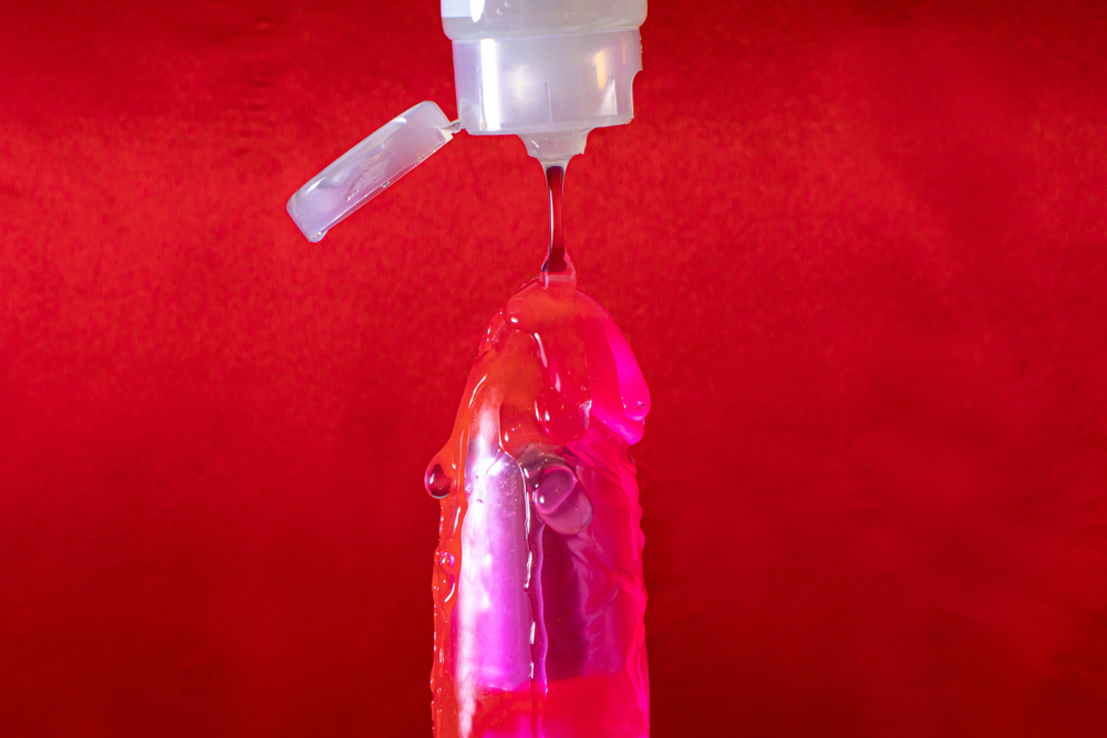 lubricant,for,sex,drips,on,a,vibrator,on,a,red